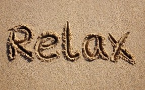 the word relax written in sand